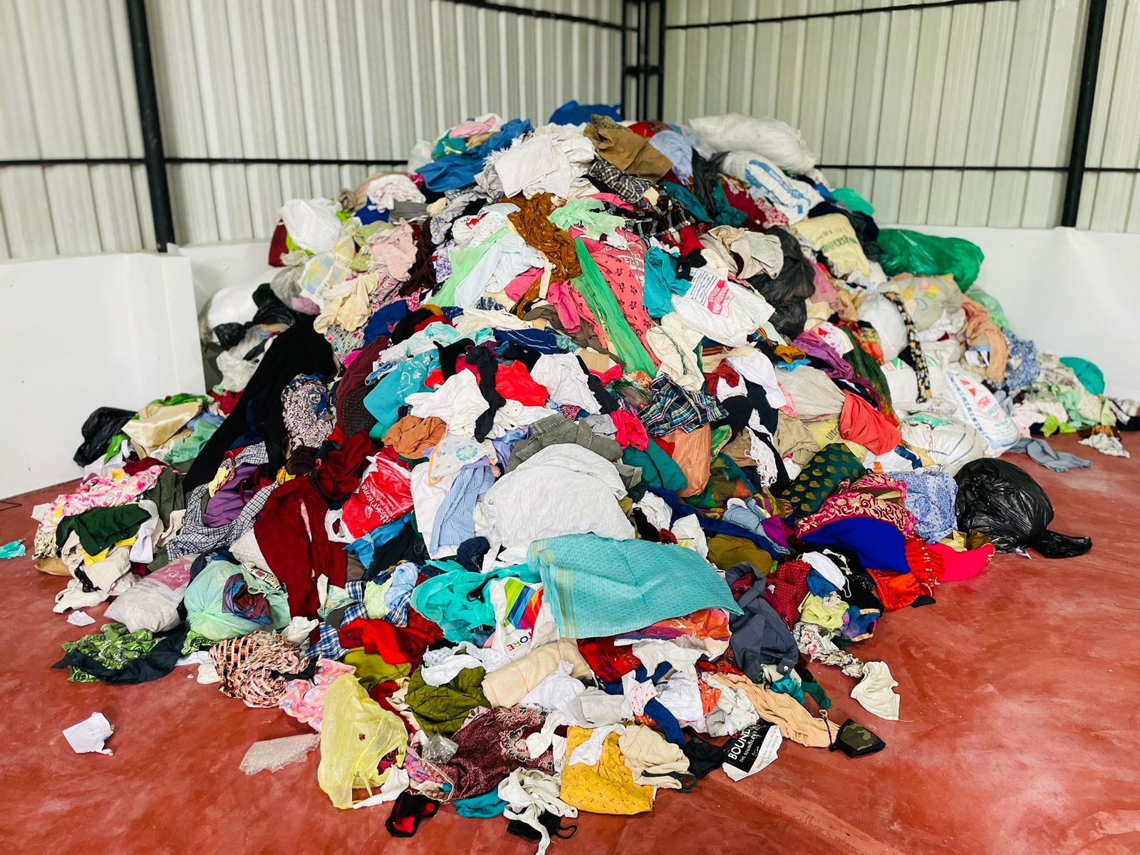 Large pile of mixed textile waste showing the scale of materials processed in recovery facilities